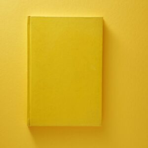 blank yellow color note pad on yellow background