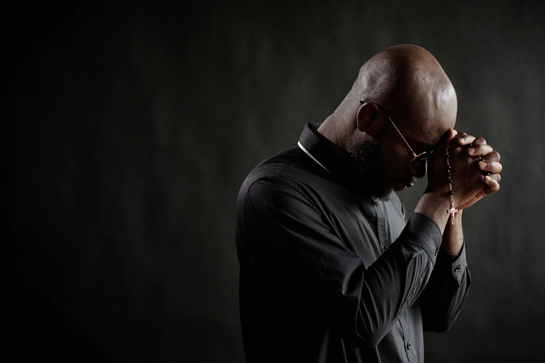 Priest praying quietly with bowed head